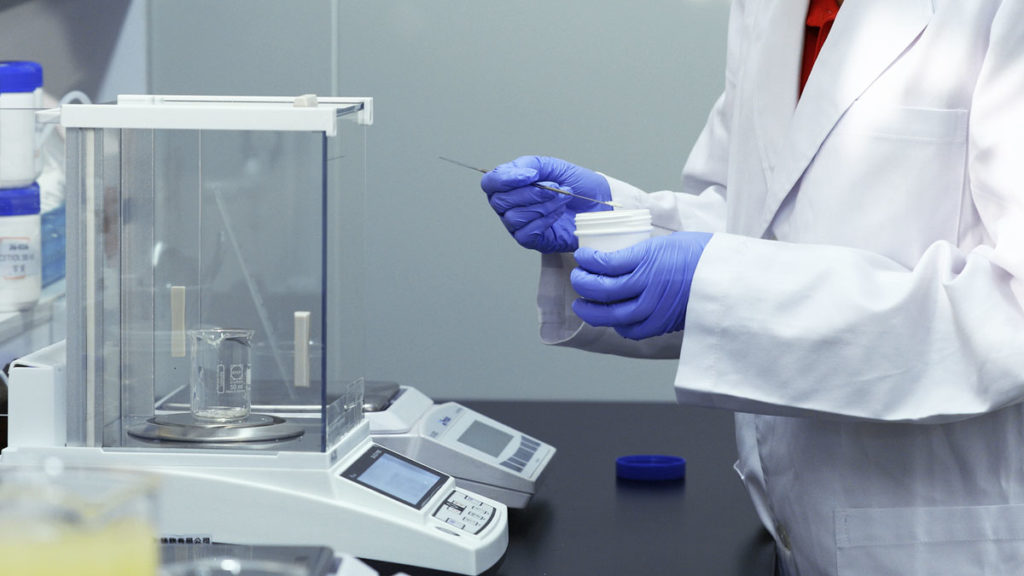Technician preparing to weigh a sample product